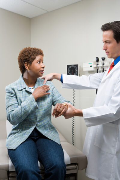 woman at a doctor's office being examined for a workers' comp claim